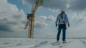 man standing on commercial roof