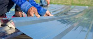 workers installing metal roof