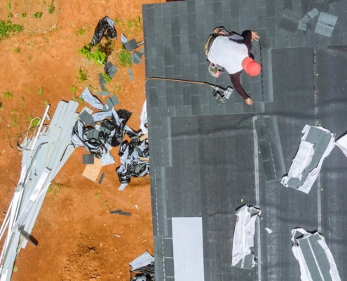Worker replacing a leaky roof