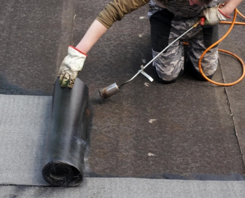 Roofer replacing a commercial roof