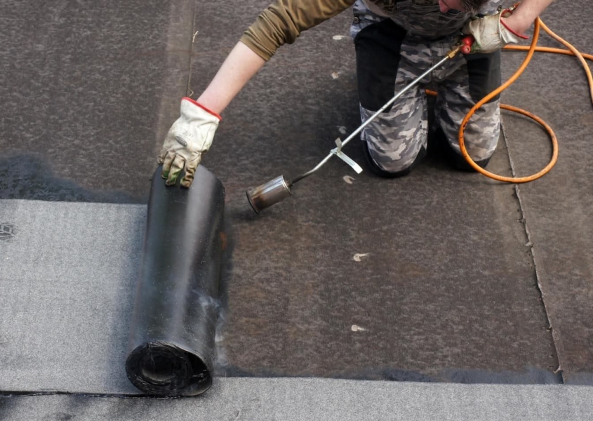 Roofer replacing a commercial roof