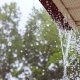 Rain water pouring off a roof during a storm