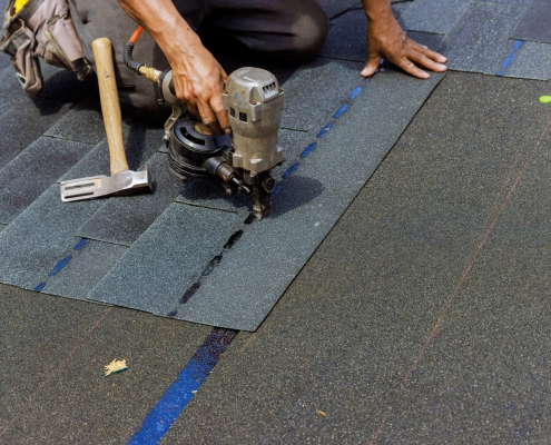 Roofer installing shingles in Dane County