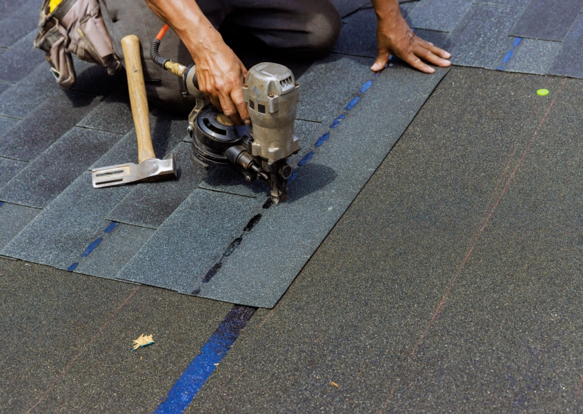 Roofer installing shingles in Dane County