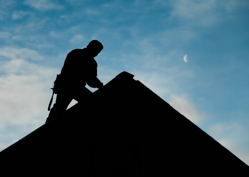 Roofing contractor in silhouette
