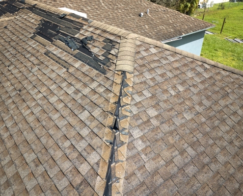 Damaged roof with missing shingles that needs replacing