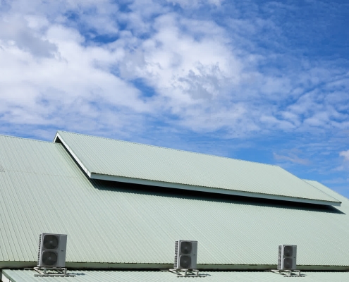Roofing crew working on commercial roof replacement project