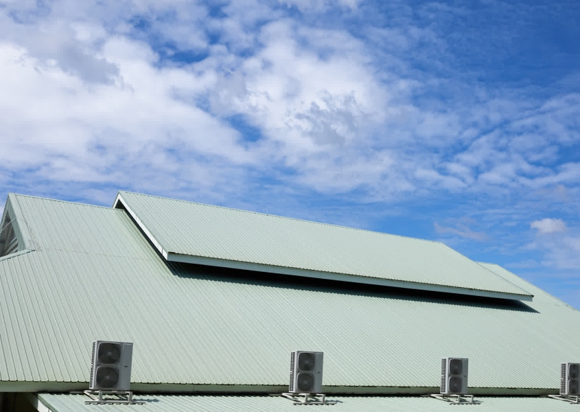 Roofing crew working on commercial roof replacement project