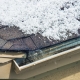 Roofer inspecting roof hail damage after a storm