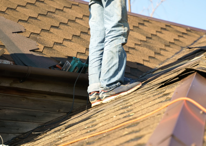 Emergency same-day roof repair being performed on leaking residential home