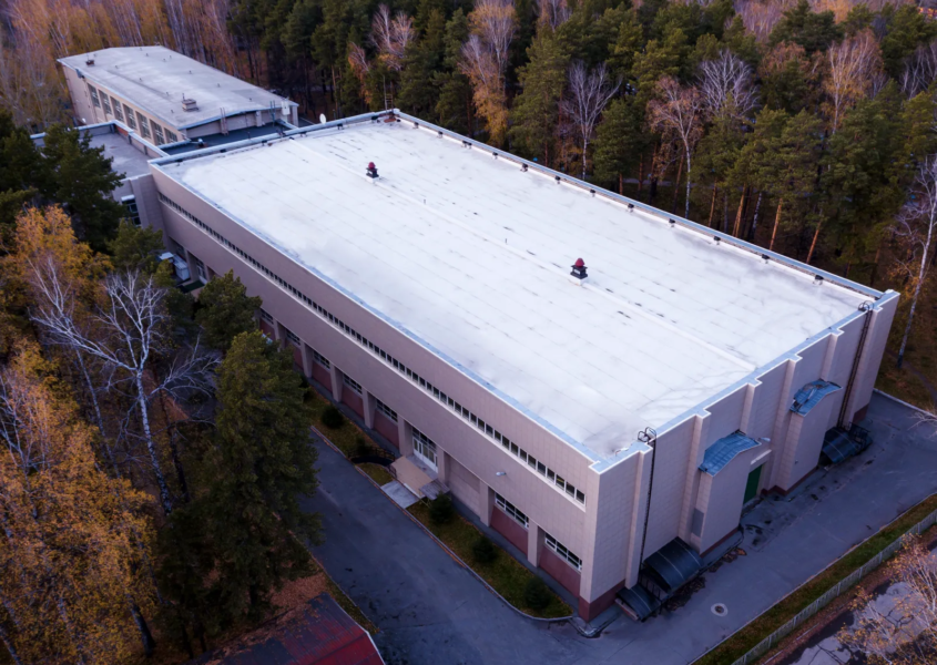 Aging flat commercial roof showing commercial roof deferred maintenance risks