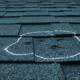 Close-up of shingles showing subtle hidden storm damage roof signs after hail