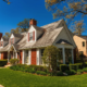 Neighboring homes, one showing premature roof aging with worn and discolored shingles