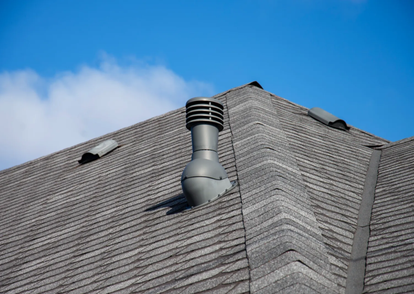 Roofer inspecting attic intake vents to identify roof ventilation problems