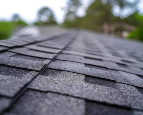 Roofer installing asphalt shingles on a residential home for a new roof project
