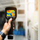 Technician about to perform an infrared roof scan on a large commercial flat roof.